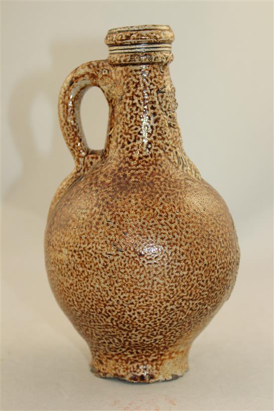 A German stoneware bellarmine jug, 16th / 17th century, 22cm.